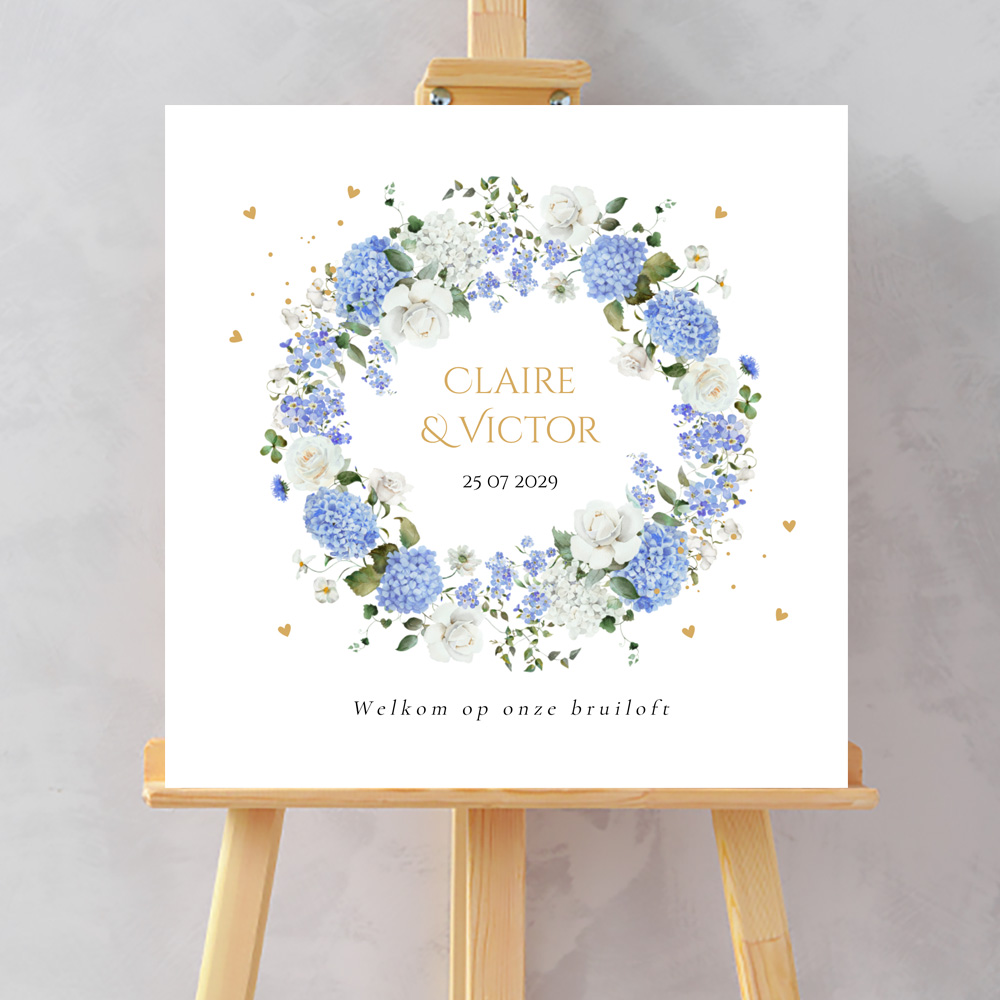 Bruiloftsbord wit bloemenkrans blauw hortensia