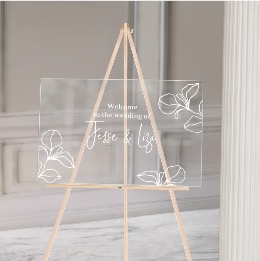 Welkomstbord bruiloft gedrukt op transparant acryl met witte bladeren
